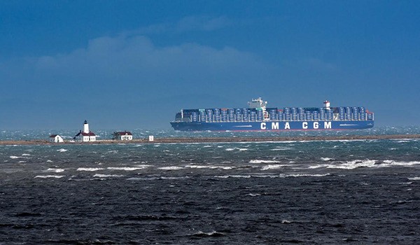 The Benjamin Franklin — the largest ship to ever call on the Port of Seattle or any U.S. port — heads west past the New Dungeness Light Station on Tuesday