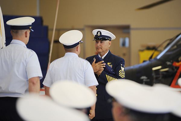 Master Chief Lawrence 'LP' Moroles accepts and American Flag at his retirement ceremony on June 11 in Port Angeles.