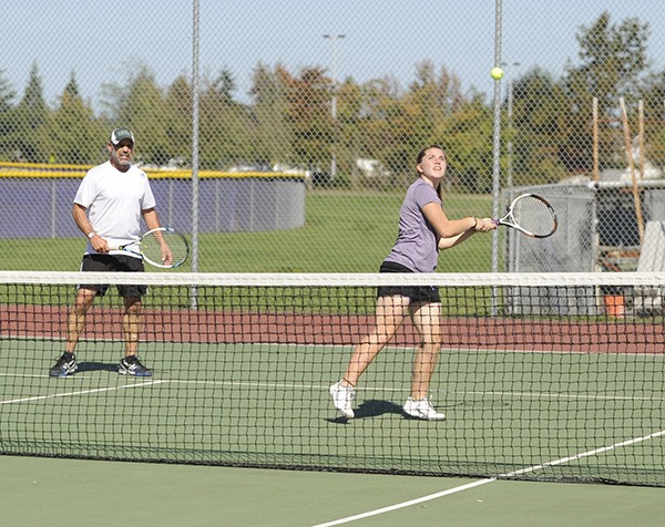 Julian Berg watches as “temporary” doubles tennis partner Katelyn Wake returns a volley at the Sequim Ultimate Doubles Tournament