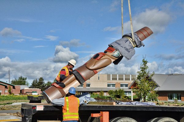 Jamestown S'Klallam clinic raises two totems in Sequim