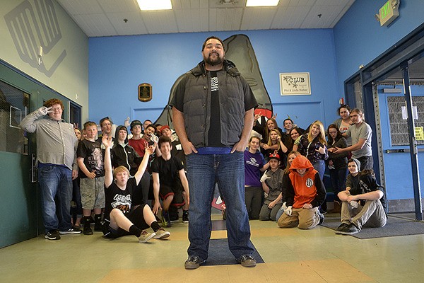 Teen Room coordinator Luke Kisena with the Boys & Girls Clubs of the Olympic Peninsula stands with many of the teens he works with at the Sequim club. He recently earned one of 12 national Maytag Dependable Leader Awards for his efforts with local teens. The club will receive $20