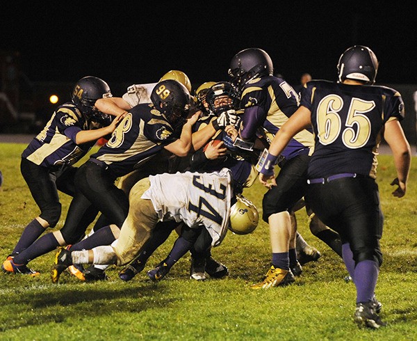 The Bremerton defense swarms to tackle Sequim running back Brandon Stamper in the first half of Sequim's 14-13 loss on Oct. 30.