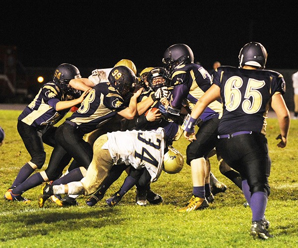 The Bremerton defense swarms to tackle Sequim running back Brandon Stamper in the first half of Sequim’s 14-13 loss on Oct. 30.