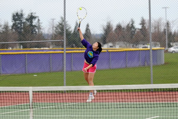 Sequim’s Melanie Guan volleys with teammates at preseason practice. The Wolves look for a repeat of 2013 when they went 12-0 in league play and won the Olympic League title.