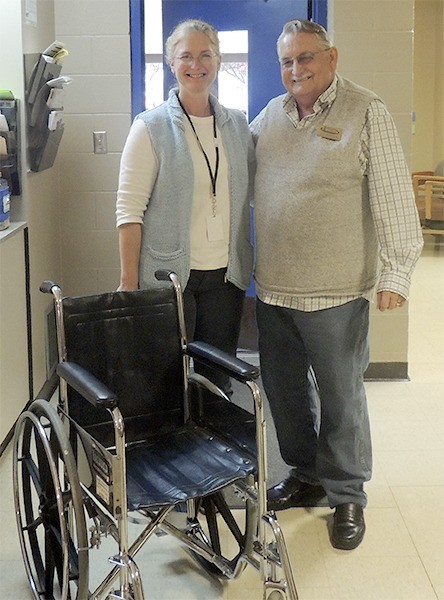 Shipley Center board vice president Joe Borden delivers a donated wheelchair to Sequim School District nurse Sonja Bittner.