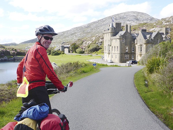 Chris Duff approaches Hebride Island Castle. Duff hosts “Two Months in Low Gear: Bicycle Touring in Ireland and Scotland