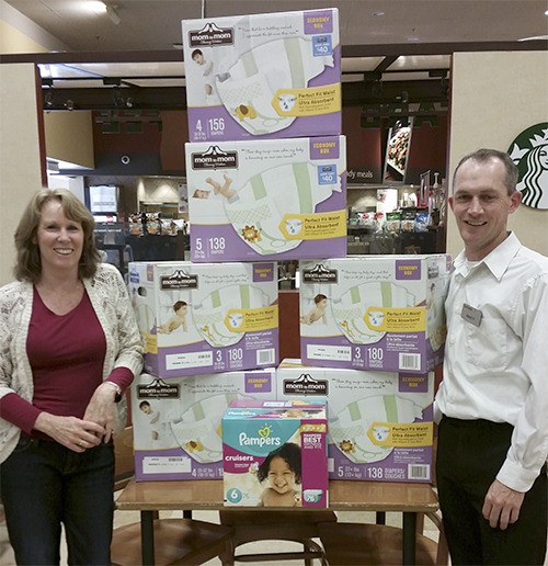 My Choices’ center manager Lori Pritchard stands with Sequim Safeway representative Isaac Peiffer in front of the diapers donated by Safeway to My Choices. My Choices is celebrating 30 years of service to the families of the North Olympic Peninsula. Services include pregnancy tests