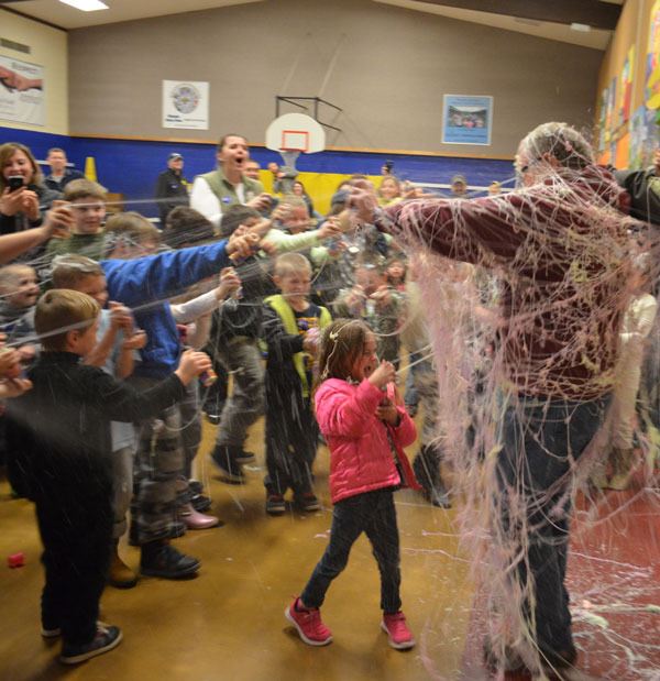 Haller Elementary Principal Russ Lodge submits to a deluge of Silly String as part of the fun at the end of Family Bingo Night.