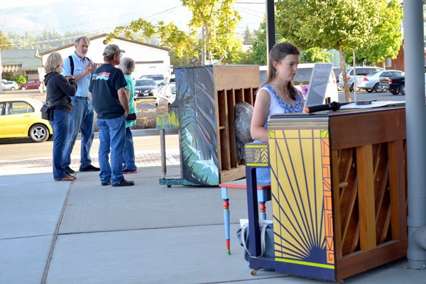 Joy Wetterlund of Port Angeles plays one of the Keying Around pianos on Aug. 5. Wetterlund said she played one of the pianos at Over the Fence while it was on display and she wanted to come back and play.