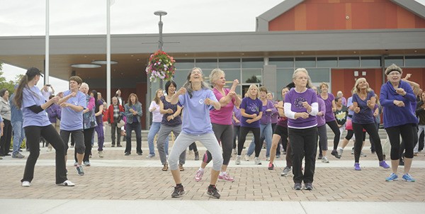 Community members join in a “flash mob” to the tune of Wilson Pickett’s “Land of 1