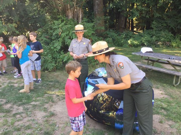 Junior Ranger Isaac Freeman gets a certificate from a park ranger last week. Fellow Junior Rangers received certificates