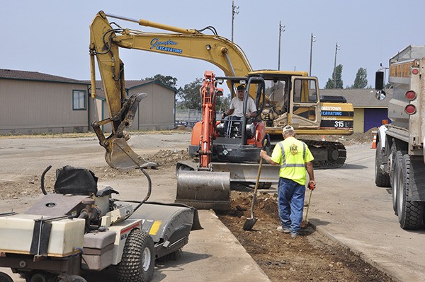 A work crew from Jamestown Excavating prepares a site for two new portables (four total classrooms) at Helen Haller Elementary School earlier this week. The portables are on the east end of the campus