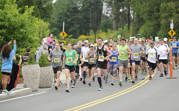 Runners break from the starting line at the 2014 North Olympic Discovery Marathon.