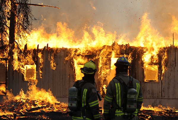 Fire District 3 personnel look on as a structure off of Graysmarsh Lane burns on Oct. 30. Cause of the blaze was found to be ‘accidental undetermined’ by District 3 officials.