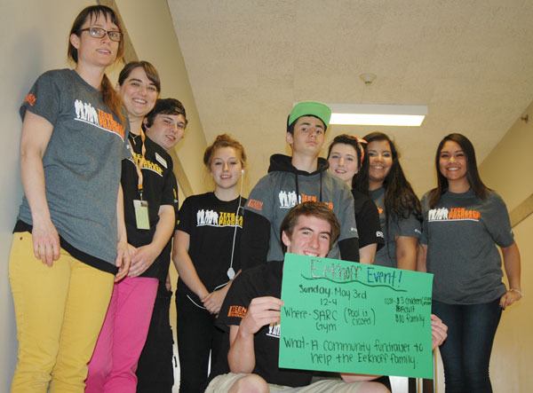 Sequim High School senior Wyatt Perdomo holds a poster for the upcoming family fundraiser he and his fellow Teen Outreach Program club members are hosting for the Eekhoffs. From left