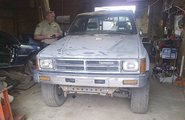 Clallam County Sheriff’s Office Detective Shaun Minks examines a stolen truck.