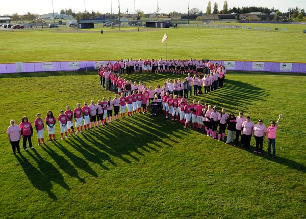 High school softball players and community members gather for a photo at the 2014 “Pink Up” event in Sequim.