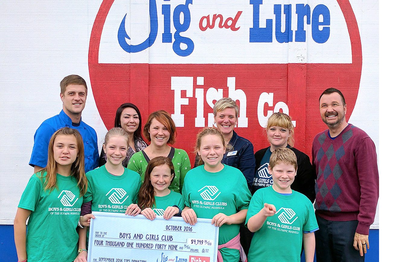 Port Angeles Boys and Girls Club members accept a check for $4,149.86 from the Jig and Lure Fish Company staff, accompanied by United Way and Boys & Girls Club staff. From back left are executive chef Brian Lippert, server Shawna Cochrum, guest services manager Christina Fenner, United Way resource development manager Christy Smith, Boys & Girls Club Port Angeles unit director Ashley Woolsey, and co-owner Stephen Fofanoff. Submitted photo