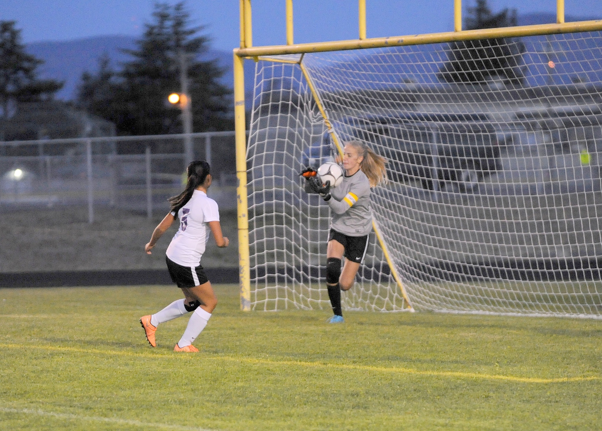 Matthew Nash/Olympic Peninsula News Group                                Sequim’s Claire Henninger (with ball) makes a save during an early-season contest.