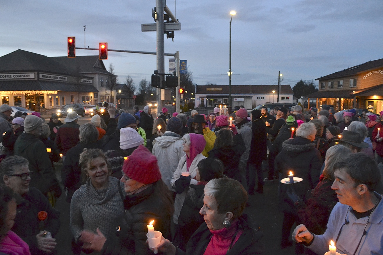 Locals gather in the evening of Jan. 21, at the southeast corner of Washington Street and Sequim Avenue for women’s rights. Organizers estimate more than 100 people attended. Sequim Gazette photos by Matthew Nash