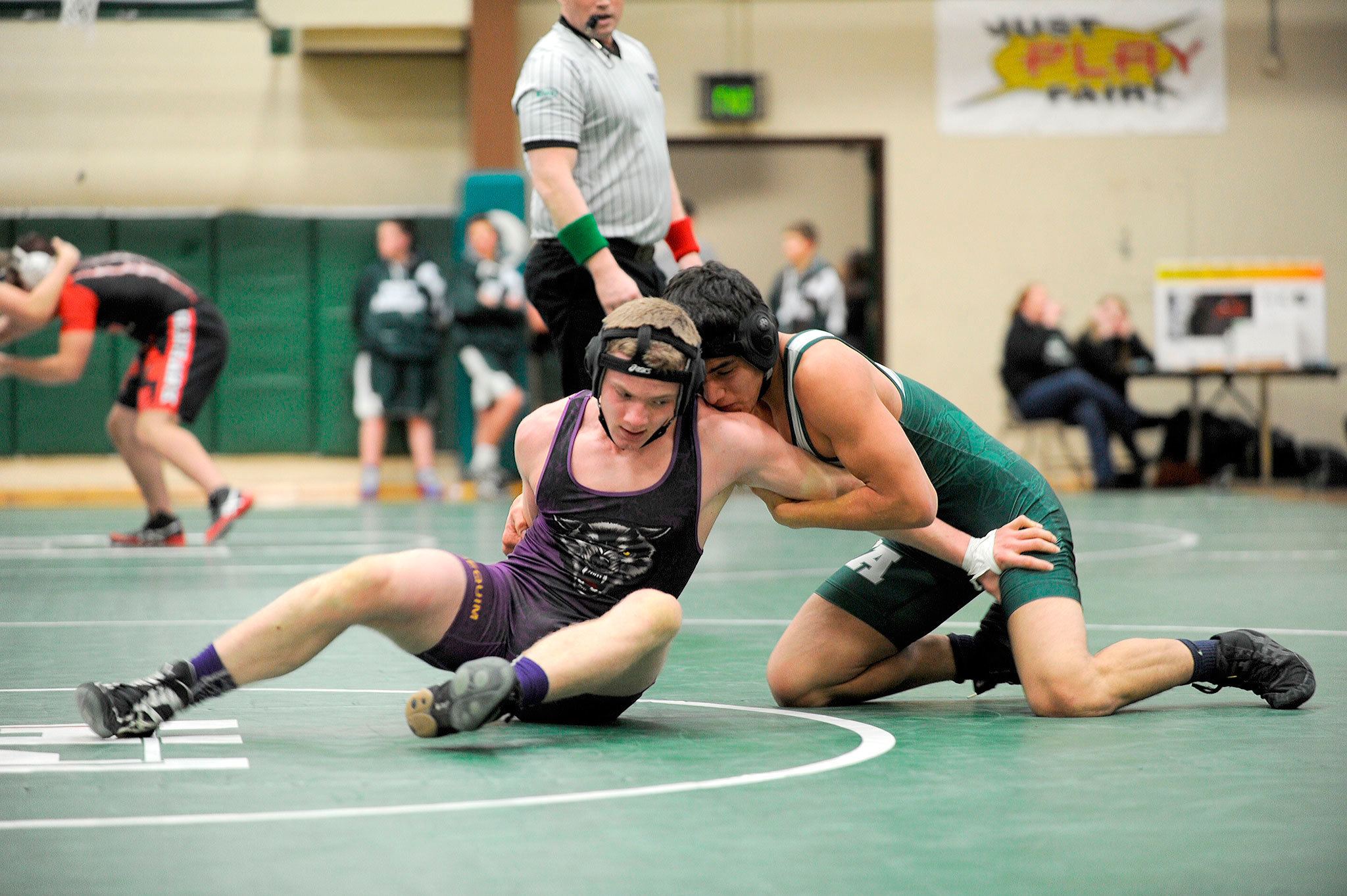 Austin Budd, 170 pounds, looks to escape a match with Thomas Blevins on Jan. 12. He went on to win 14-10. Sequim Gazette photo by Matthew Nash