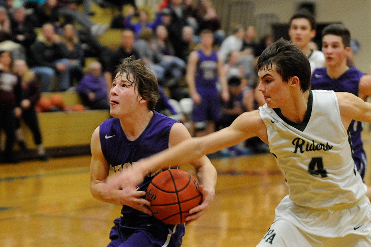 Boys basketball: ‘Riders ride fourth quarter wave in 66-35 romp over Sequim