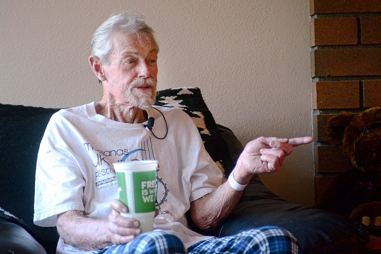 Richard Jones, 69, talks to reporters in his Sequim-area home Monday after being rescued from his car earlier that morning. He was trapped in his car for five days. Jesse Major/Peninsula Daily News