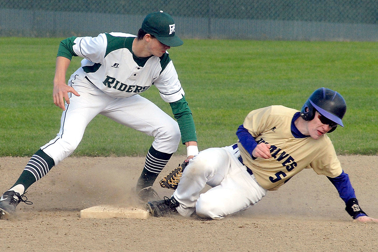 Port Angeles’ Colton McGuffey, left, cuts off a second base steal attempt by Sequim’s Justin Porter in the third inning on April 26 at Volunteer Field in Port Angeles. Photo by Keith Thorpe/Peninsula Daily News