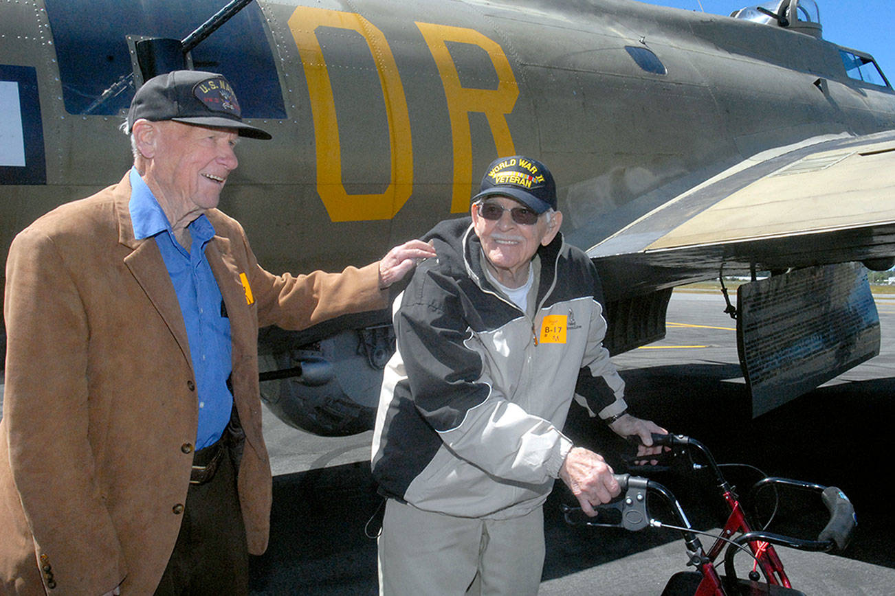 Veterans Frank Meek of the U.S. Navy and Don Alward of the U.S. Marine Corps show delight at the end of their flight aboard a restored B-17 bomber on Wednesday at William R. Fairchild International Airport in Port Angeles. Keith Thorpe/Peninsula Daily News