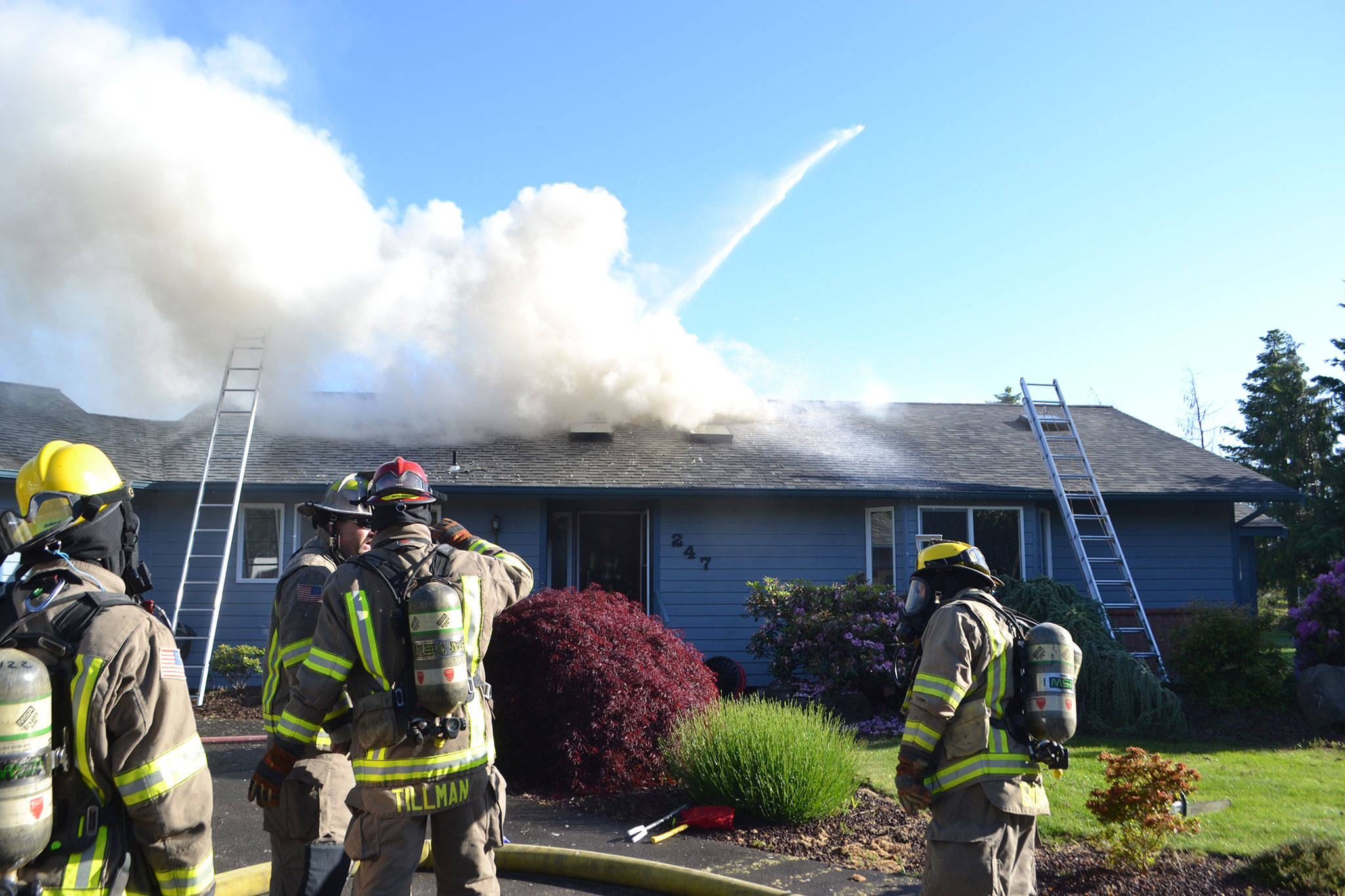 A fire spreads through the attic of a home on the 200 block of Griffith Farm Road on Sunday, June 4. Clallam County Fire District 3 with support from Clallam County Fire District 2 extinguished the fire in about two hours but the damage has displaced the homeowners. Sequim Gazette photos by Matthew Nash