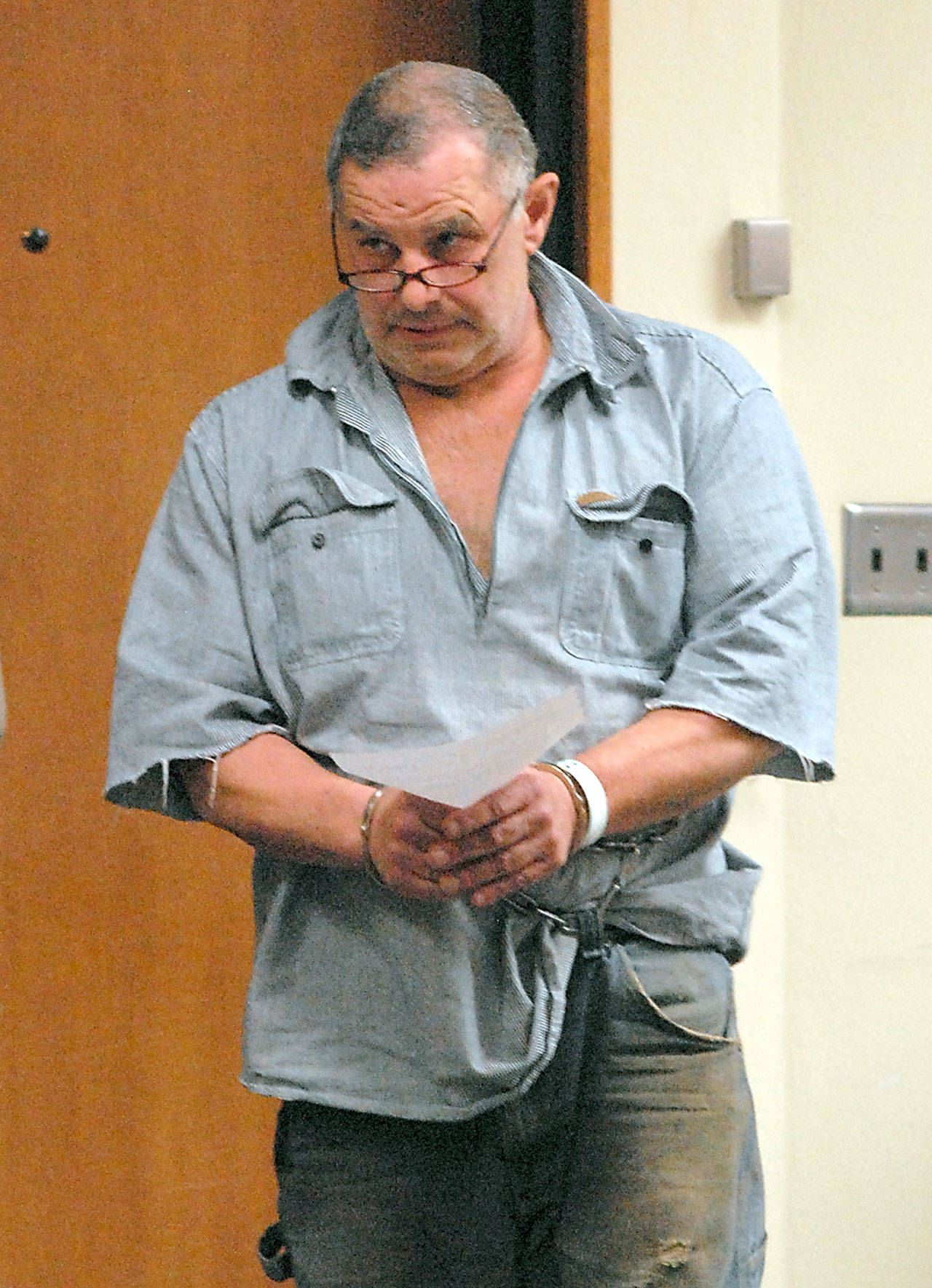 Keith Thorpe/Peninsula Daily News Roger Garman of Sequim enters Clallam County Superior Court in Port Angeles on Tuesday in connection with alleged threats made to a Jamestown S’Klallam school bus driver and the tribal office.