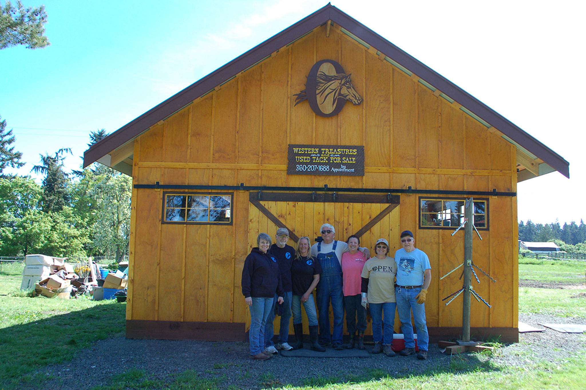 Olympic Peninsula Equine Network President Valerie Jackson, Board members Steve Lange, Diane Royall, Mike Vaillancourt, and volunteers Lynn Hawkins, Linda and Bill Baun stand outside the nonprofit’s new Western Treasures and Used Tack store at 251 Roupe Road in Sequim set to open at noon on May 9. Sequim Gazette photo by Erin Hawkins