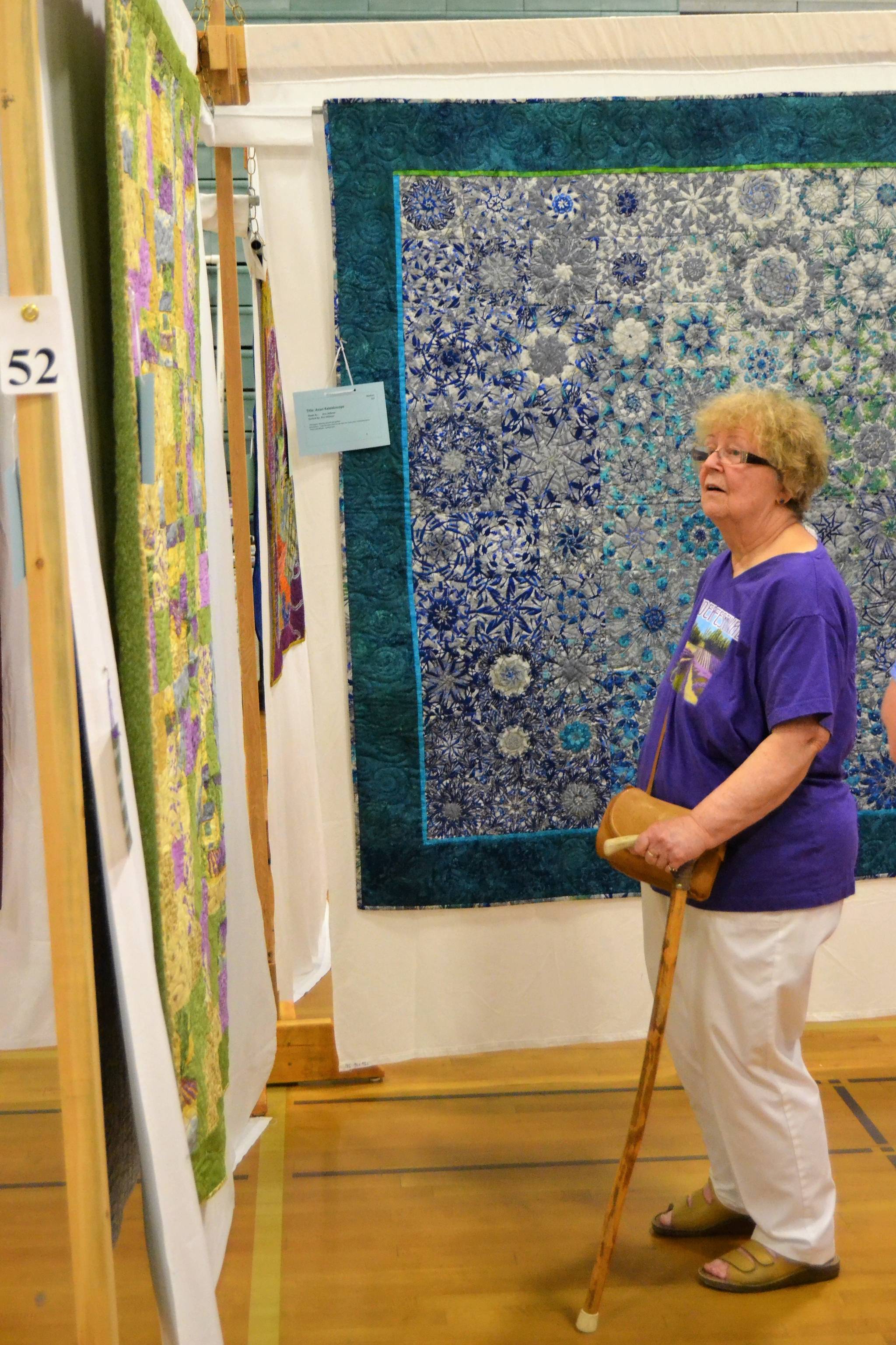 Mary Pat Minor of Sequim admires a quilt at the Sunbonnet Sue Quilt Club’s annual show on July 21 inside Sequim Middle School. Minor said she’s come to the show every year since 2011. Sequim Gazette photo by Matthew Nash