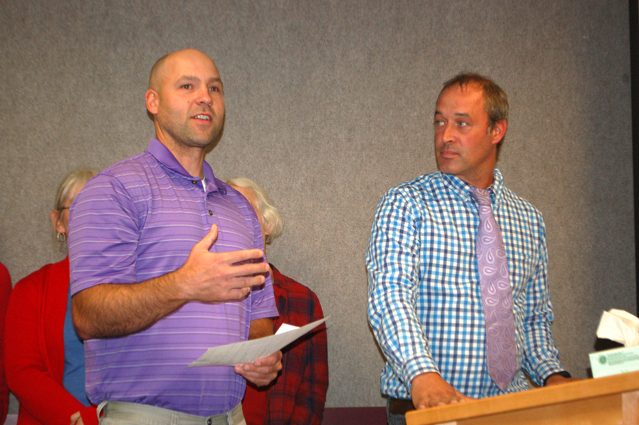 Isaac Rapelje, a Sequim High School teacher and union negotiator, left, stands with Sequim Education Association president, Aaron Reno, as they present the new two-year collective bargaining agreement that gives teachers a 12.5-14 percent raise to the Sequim School Board on Sept. 10. Sequim Gazette photo by Erin Hawkins