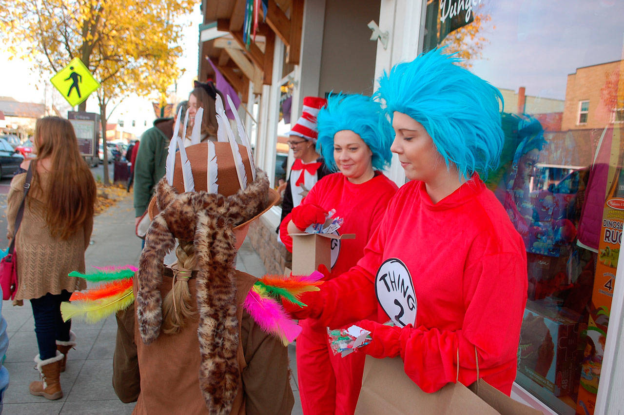 Marissa Santjer (Thing 1) and Anna Santjer (Thing 2) hand out candy during last year’s Merchant Trick or Treating event downtown last year. The event continues this year from 3-5 p.m. Wednesday, Oct. 31. Sequim Gazette file photo by Erin Hawkins