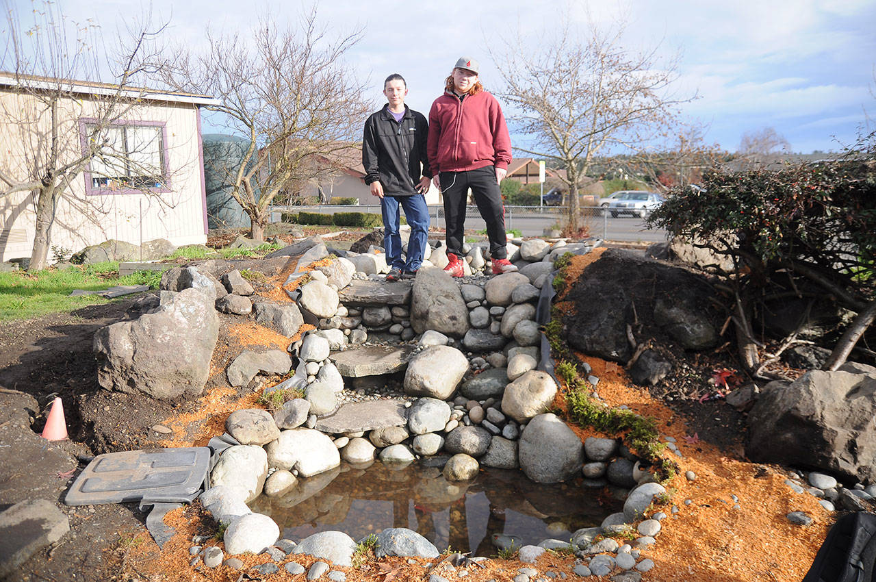 Tristin Holbert, left, and Chance Sare, both freshmen at Sequim High School, helped spearhead a class project to build a pond on the SHS campus in recent weeks. Sequim Gazette photo by Michael Dashiell