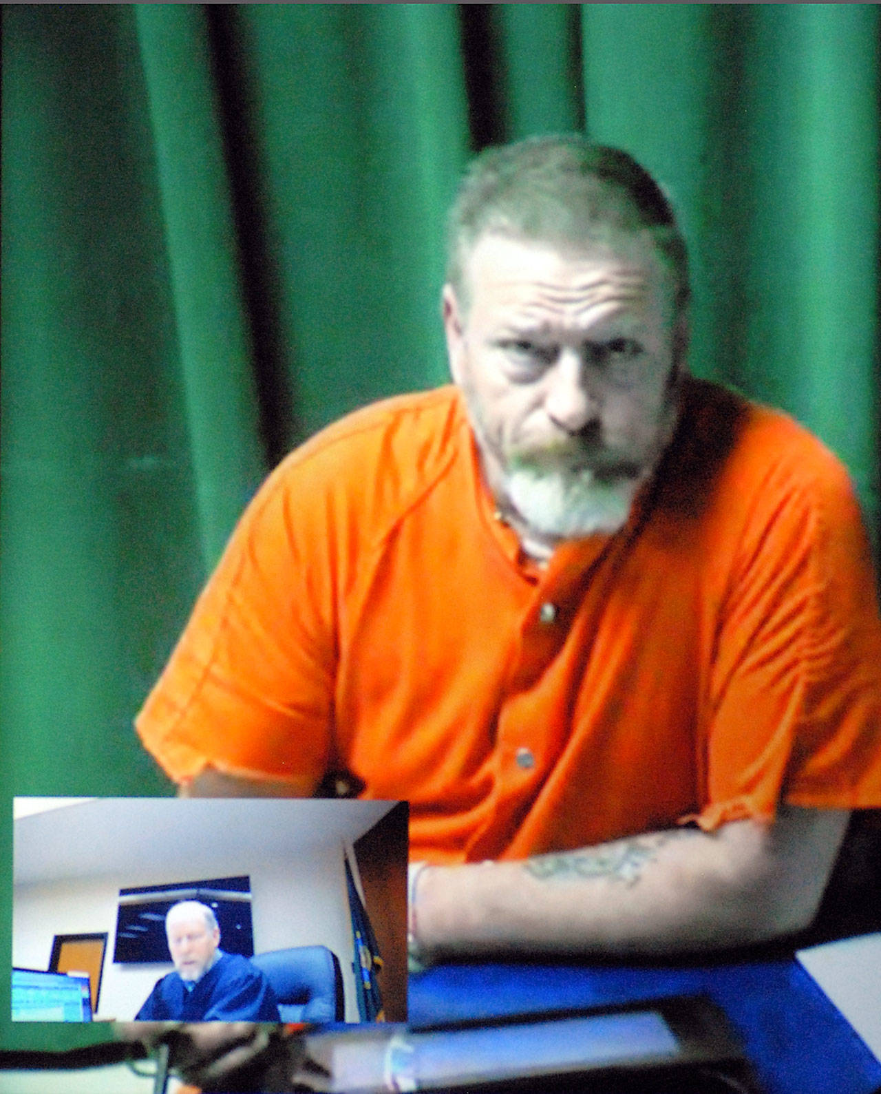 Dennis Bauer makes his first video appearance in Clallam County Superior Court in Port Angeles on Friday after he was arrested Thursday in connection with a triple homicide in December. Inset in the two-way video appearance is Superior Court Judge Brian Coughenour. (Keith Thorpe/Peninsula Daily News)