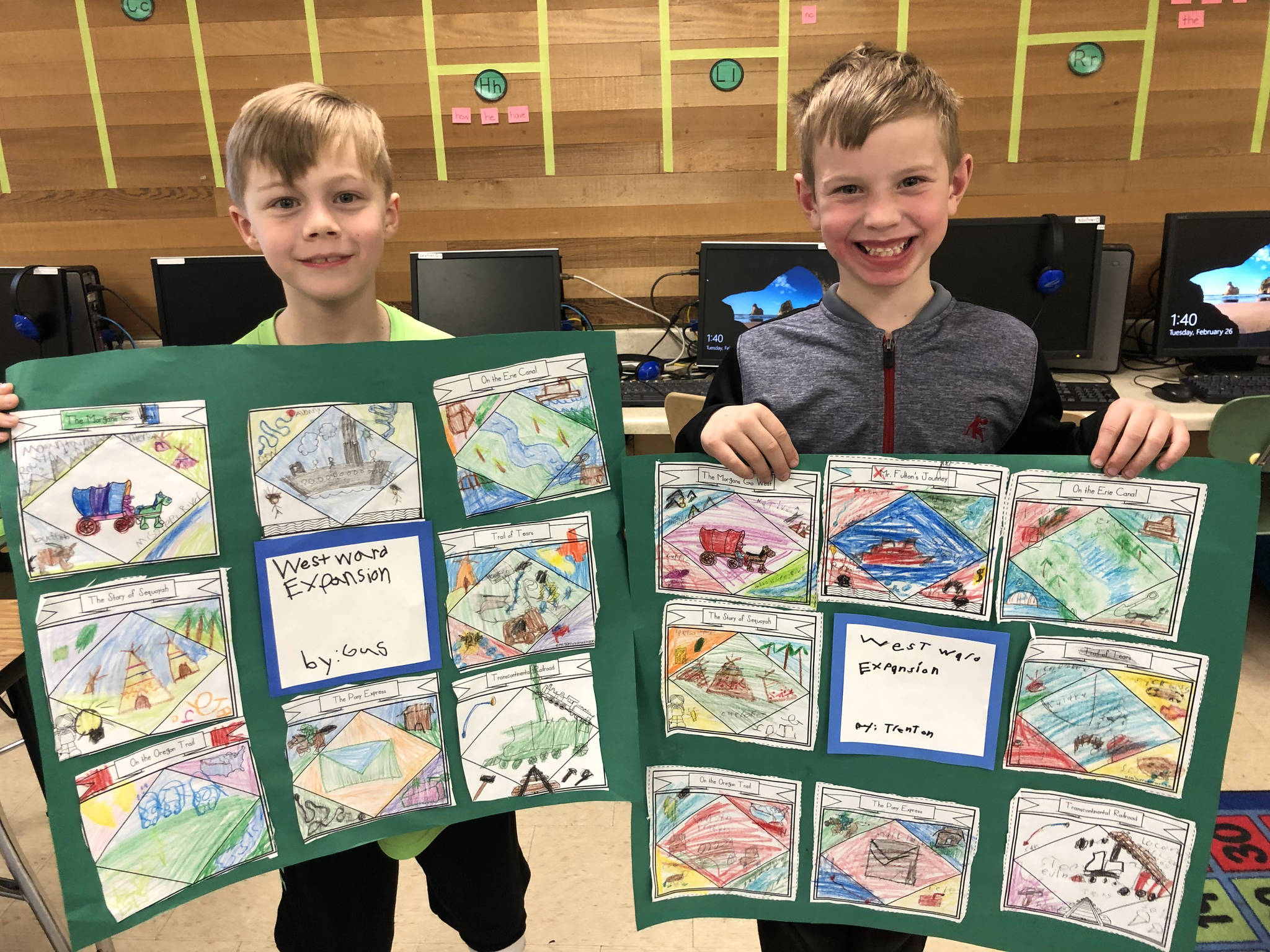 Second-graders Gus Mecham, left, and Trenton Kardonski show their displays about westward expansion in the United States during the 1800s. Submitted photo