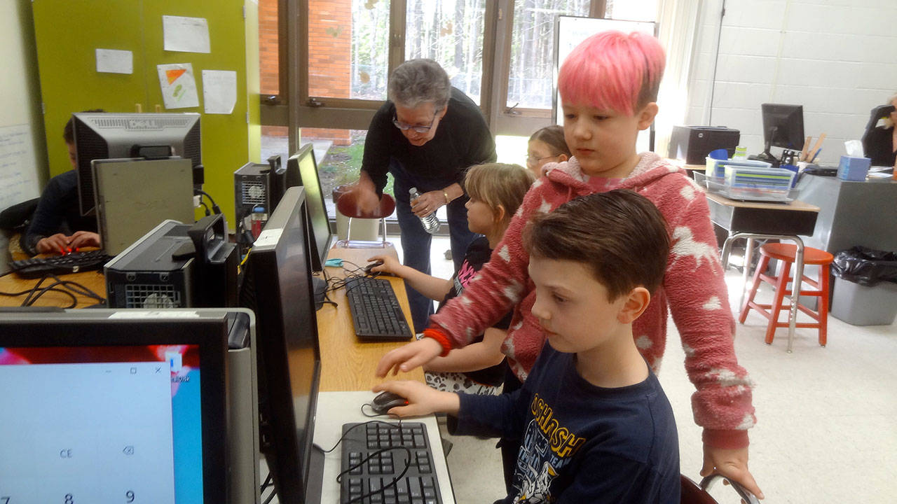 Sherri Smith with the Sequim PC Users club helps students work on computers at Roosevelt Elementary’s second session of Computer Club, including from front to back, Jacob Burkhardt, Aiden Johnson, a student helper, Kairi Latson and Madison Feller. Photos courtesy of Dick Wolf