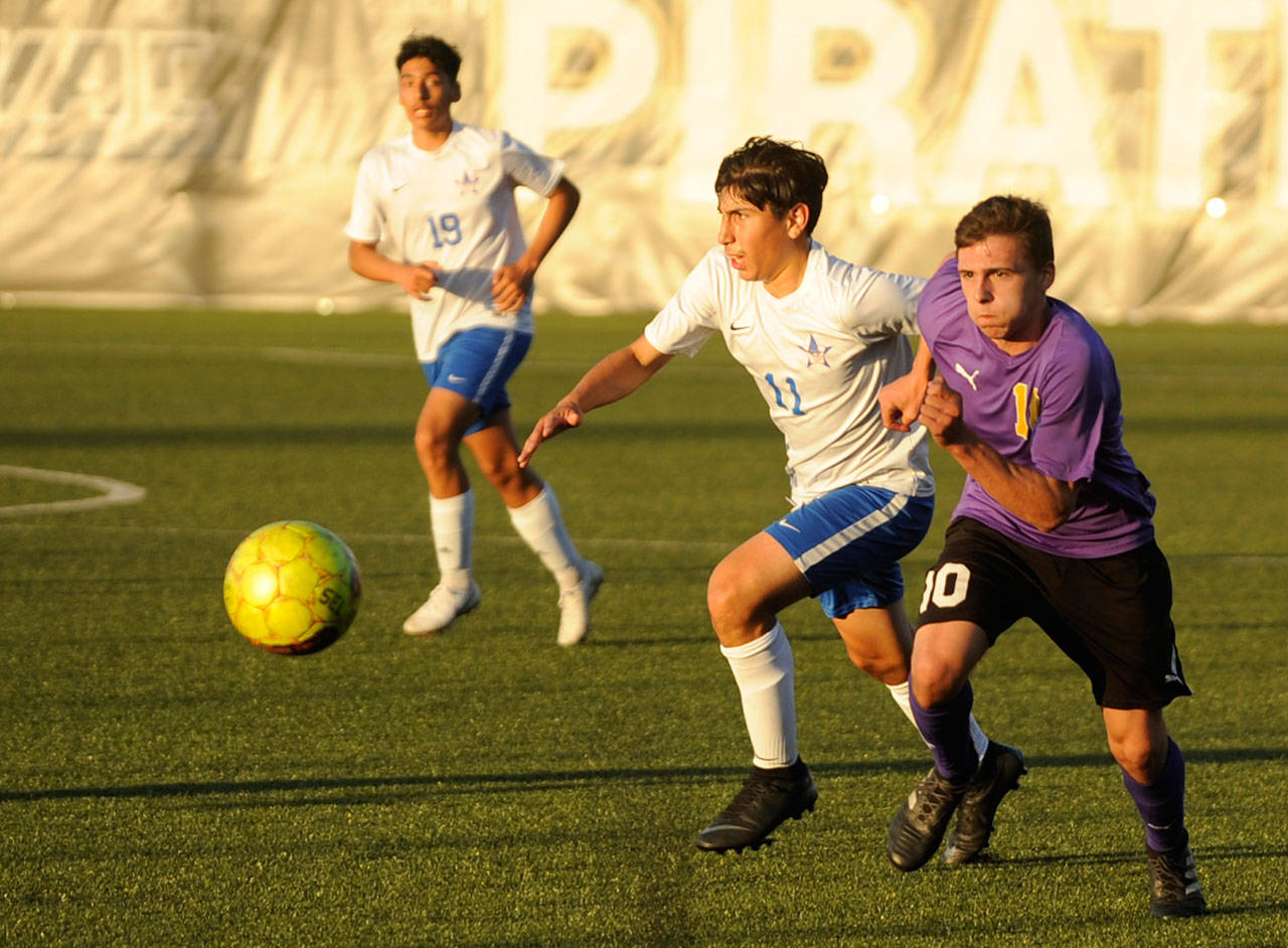 Sequim’s Mathys Tanche, right, drives deep into Washington territory in the Wolves’ 4-2 district playoff win on May 7 in Port Angeles. Tanche had Sequim’s fourth goal of the game and lone second half score. Pursuing the play is Miguel Plancarte (11) and Saul Talavera (19). Sequim Gazette photo by Michael Dashiell