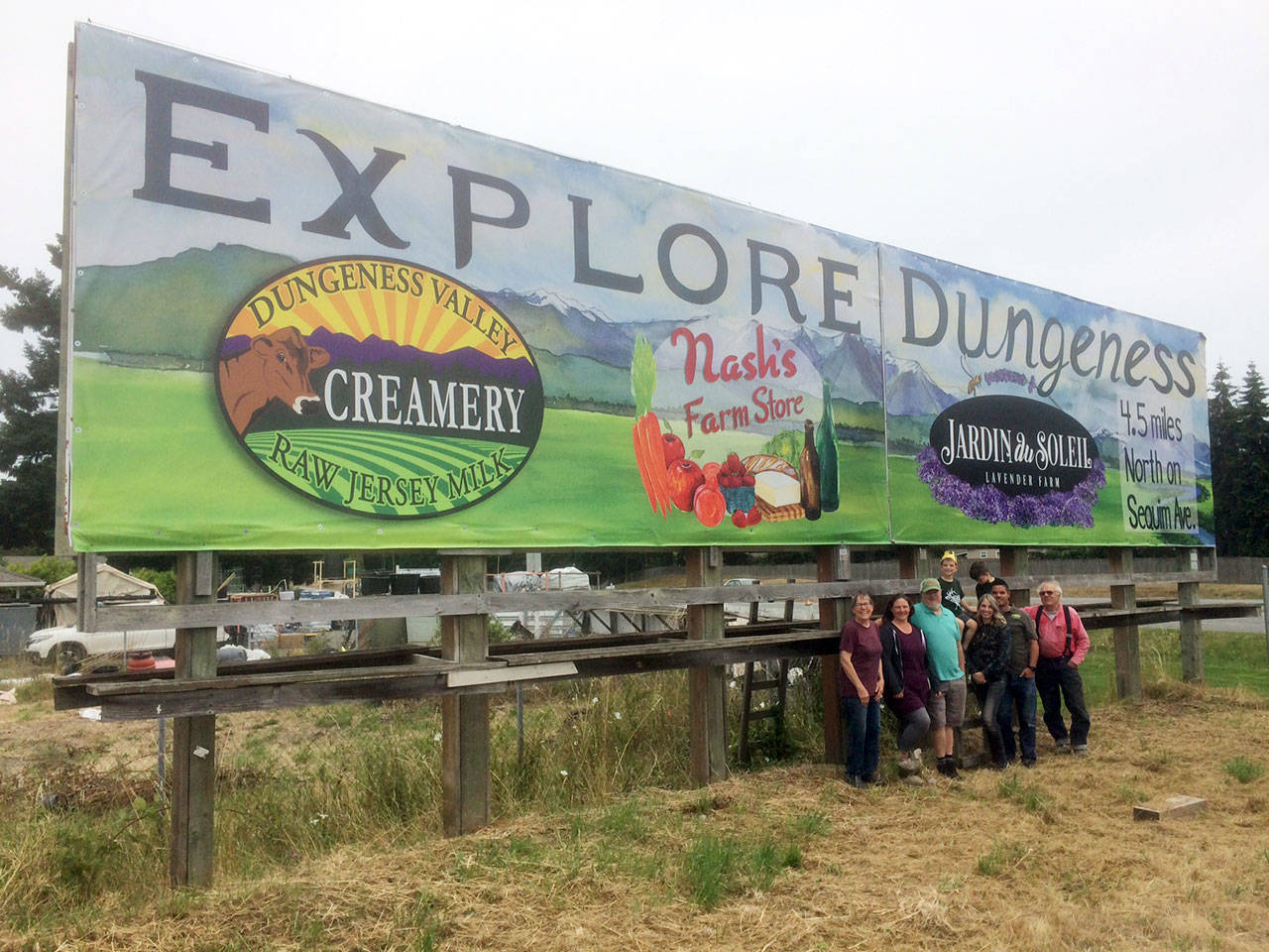 From left, Patty McManus (Nash’s Farm Store), Jordan and Paul Schiefen (Jardin du Soleil); Wade, Sarah, Ryan and Tyler McCarthey (Dungeness Valley Creamery) and Nash Huber (Nash’s Farm Store) stand near a new billboard promoting the three businesses. Submitted photo