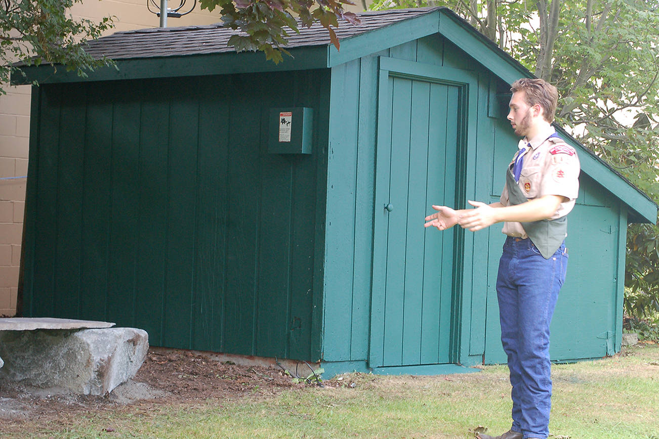 Ian Thill describes the work done to restore and enhance a storage shed at Pioneer Memorial Park for his Eagle Scout project. He said the job wound up being “much more work” than anticipated, with several additional structural elements of the shed getting replaced in addition to the planned roof replacement. Sequim Gazette photo by Conor Dowley