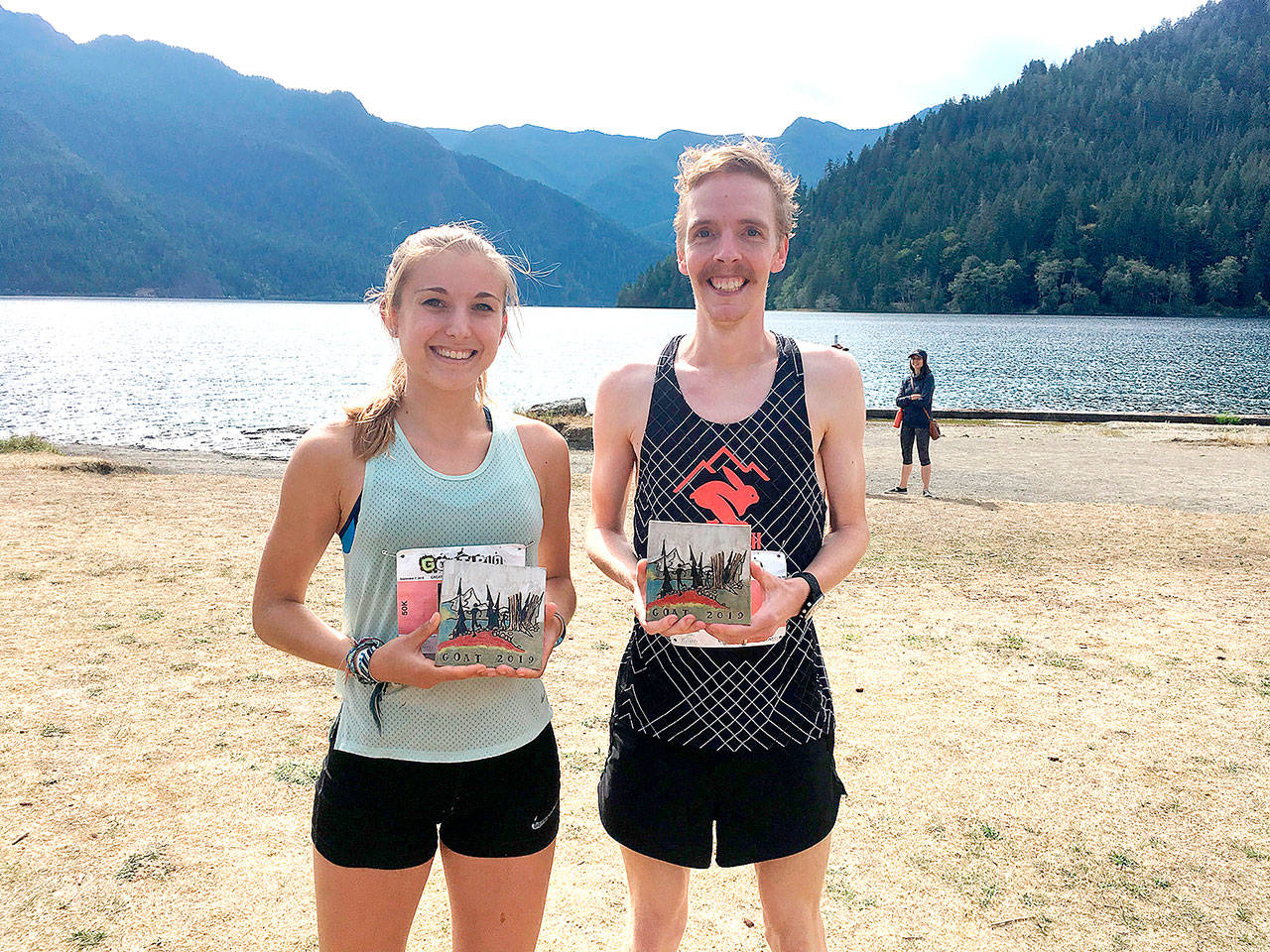 Kristina Randrup of Berkeley, Calif., and Keith Laverty of Bainbridge were the winners of the 2019 50K GOAT Run, held Saturday from Granny’s Cafe to the northwestern shore of Crescent Lake. Laverty also won the 2018 Rhody Run, the 2018 North Olympic Discovery Marathon and this year’s NODM 10K event. Their ceramic awards were made by Gay Hunter. (Peninsula Adventure Sports)