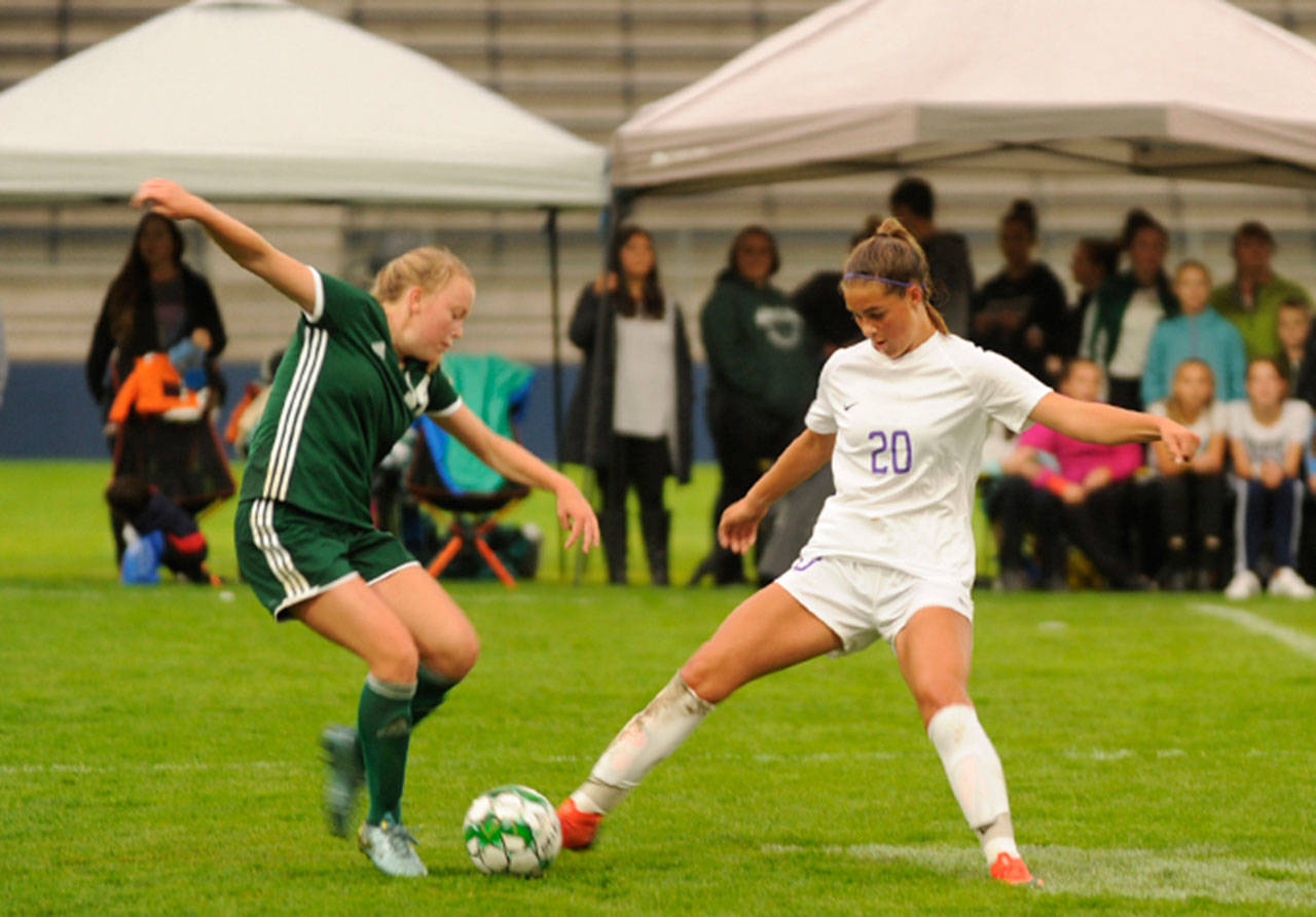 Sequim’s Hope Glasser, right, and Port Angeles’ Anna Petty vie for the ball in the Roughriders’ 4-1 win on Sept. 12. Sequim Gazette photo by Michael Dashiell