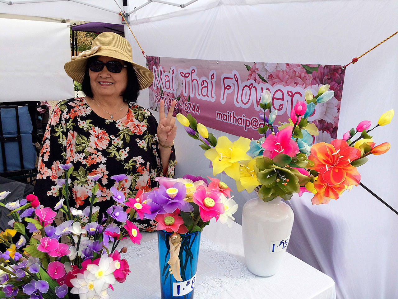 Waan Whitaker of Mai Thai Flowers displays her silk flowers at the Sequim Farmers Market. Photo courtesy of April Hammerand/Sequim Farmers Market