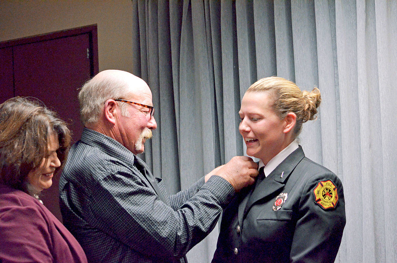 Newly promoted Lieutenant Stephanie Anderson, right, is pinned by her parents, Penny and Curt Gates. Photo courtesy of Fire District 3