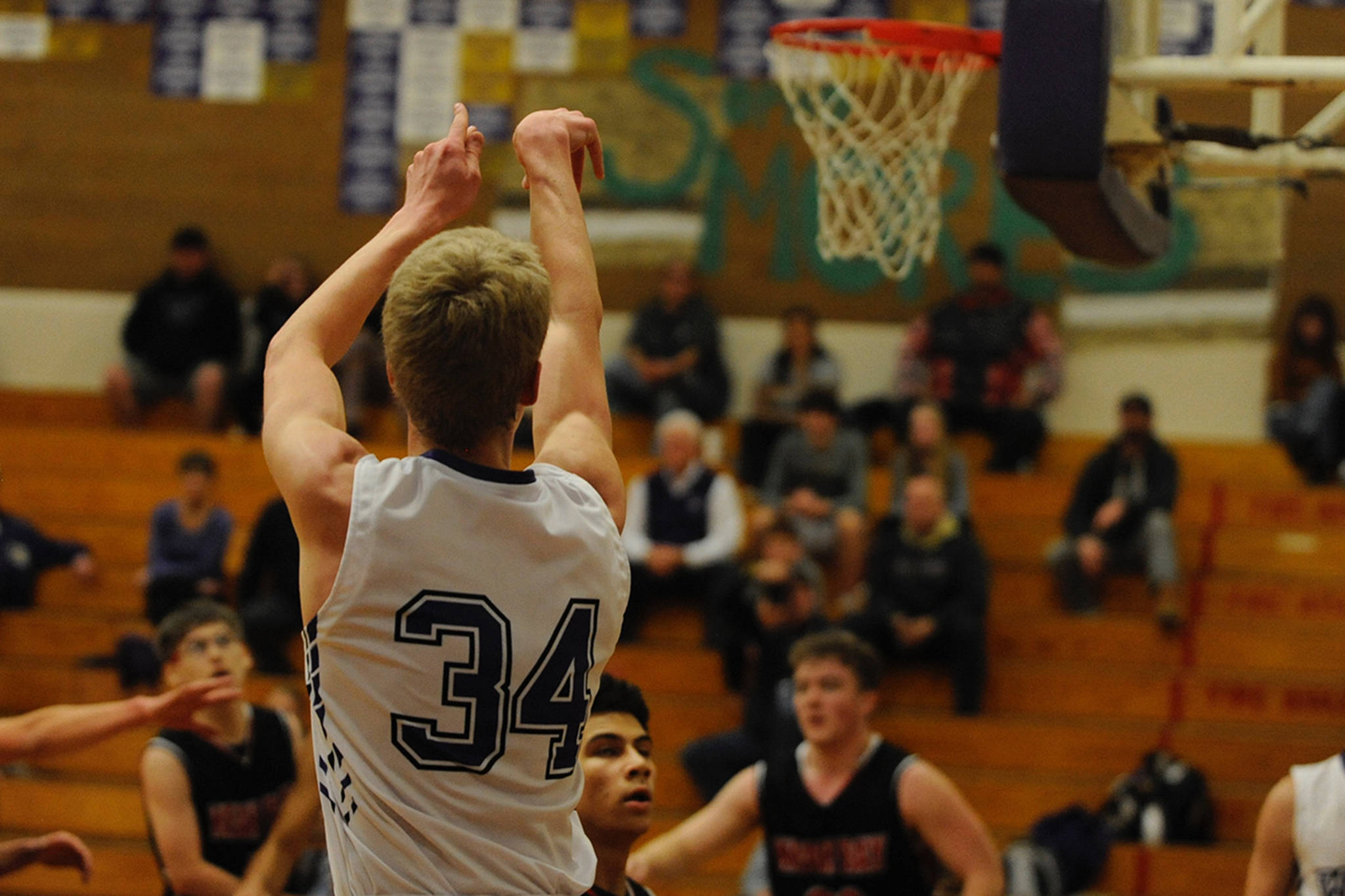 Erik Christiansen, pictured shooting a three pointer against the Neah Bay Reds on Dec. 4, scored 28 points that night after scoring 13 during the team’s season opener against Klahowya on Dec. 2. Sequim Gazette photo by Conor Dowley