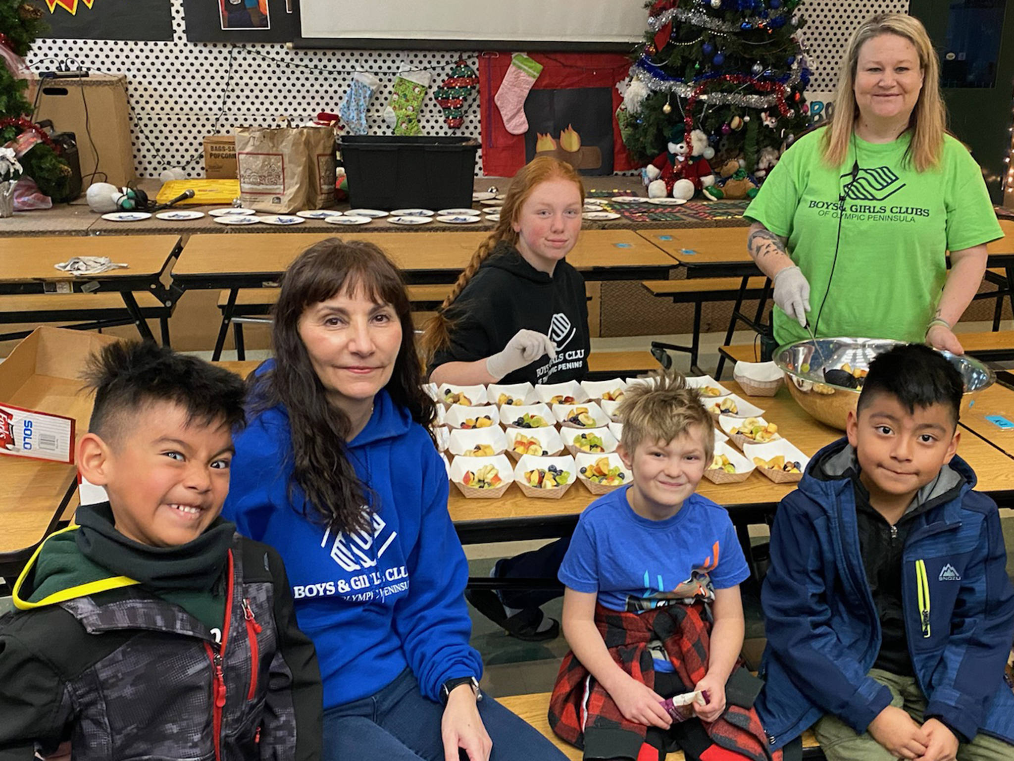 Mary Budke, second from left, sits with, from left Andres Yescas, intern Nicole Fearn, Scotty Janssen, program director Tessa Jackson and Elisio Zaragoza in the games room of the Carroll C. Kendall Unit of the Boys & Girls Clubs of the Olympic Peninsula in Sequim. Submitted photo