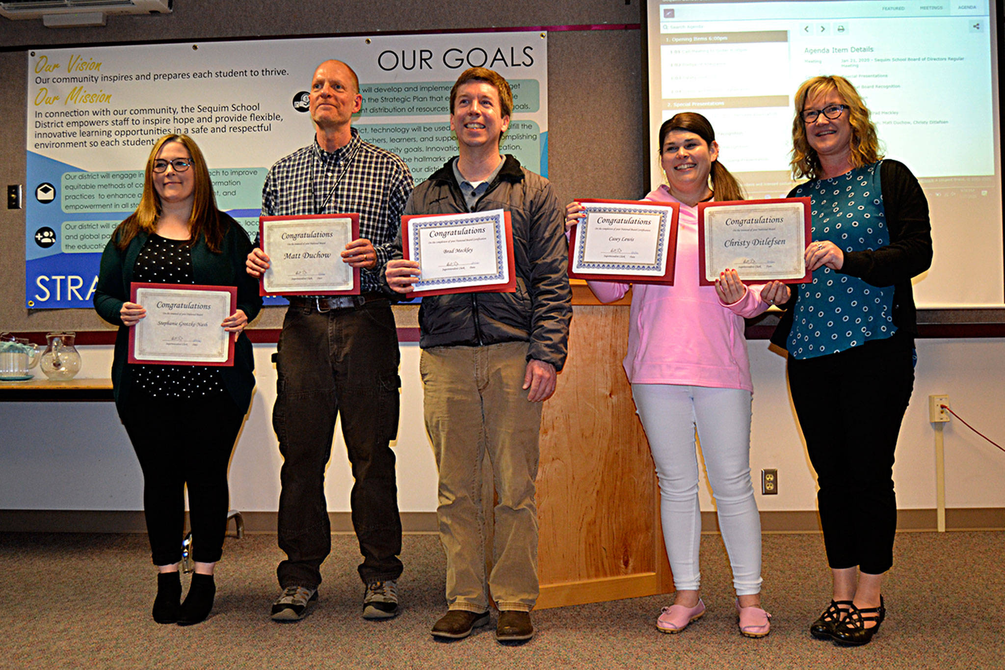 Jennifer Maughan, Sequim assistant superintendent, on right, recognized five National Board Certified teachers on Jan. 21, including from left, Stephanie Grotzke-Nash, Matthew Duchow, Brad Meckley and Casey Lewis; not pictured, Christy Ditlefsen. Maughan said they worked on the voluntary certification program an average of 200-400 hours. Sequim Gazette photo by Matthew Nash