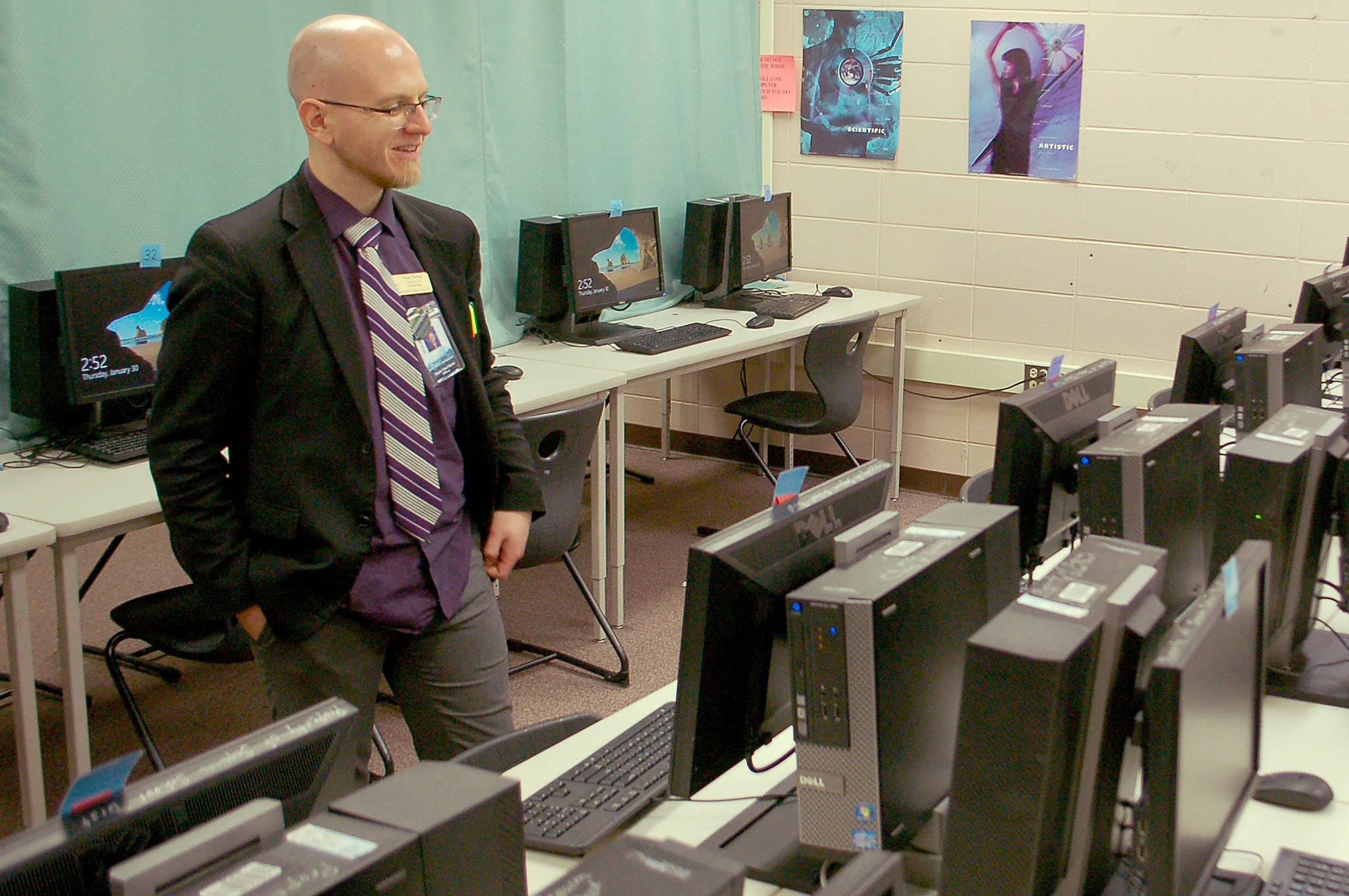 Sequim School District information technology director Beauregarde Young looks over the computers in the upstairs computer lab at the Sequim High School library. Young noted that these computers are some of the newer computers in the district, but still suffer from many of the limitations that the district’s aging technology infrastructure creates. Sequim Gazette photo by Conor Dowley